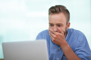 netwealth-nwl-netwealth-share-price-asx-Closeup of Shocked Young Man Working on Laptop