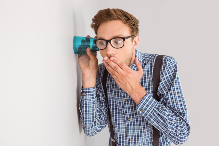 vocus-share-price-voc-asx-Geeky businessman eavesdropping with cup on grey background