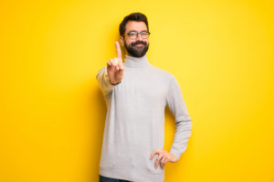 asx etfs ivv. Man with beard and turtleneck showing and lifting a finger