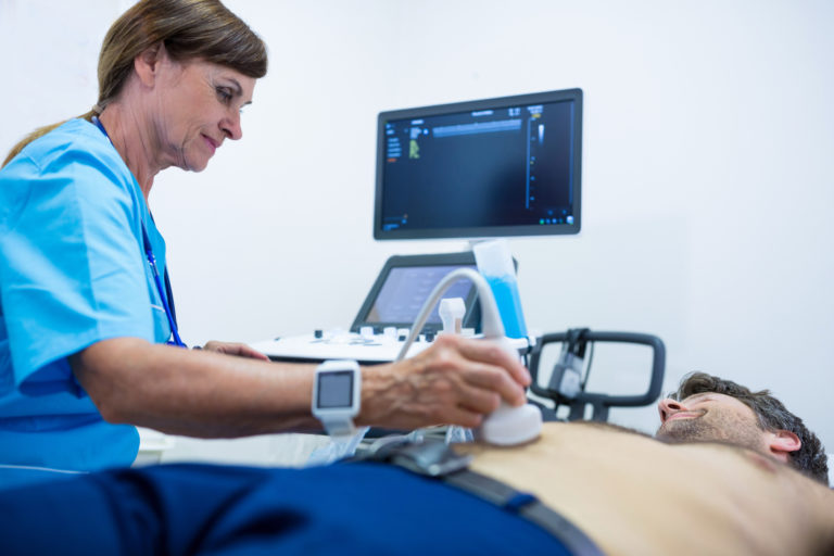 Man getting ultrasound of a abdomen from doctor