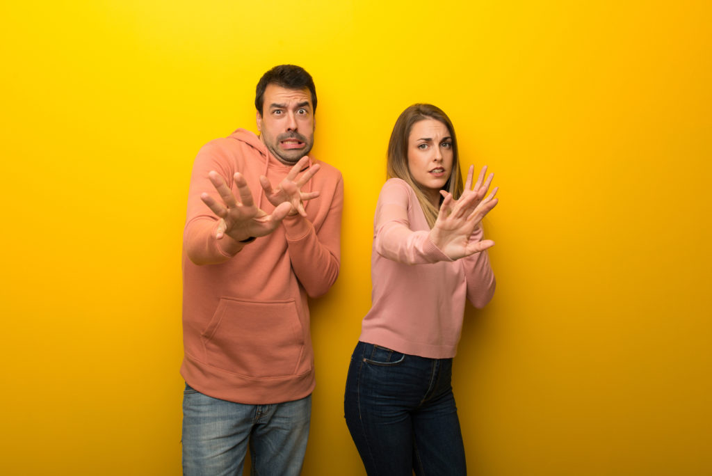 asx 200. image shows couple look scared or fearful at the camera