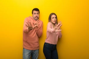 asx 200. image shows couple look scared or fearful at the camera
