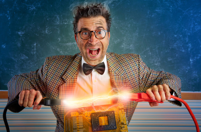 pro medicus. image shows a man wearing a bow tie holding electrical cables over a piece of software. he's being electrified.