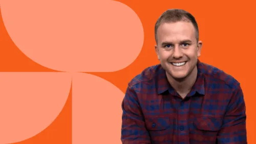 Headshot of Owen with orange background