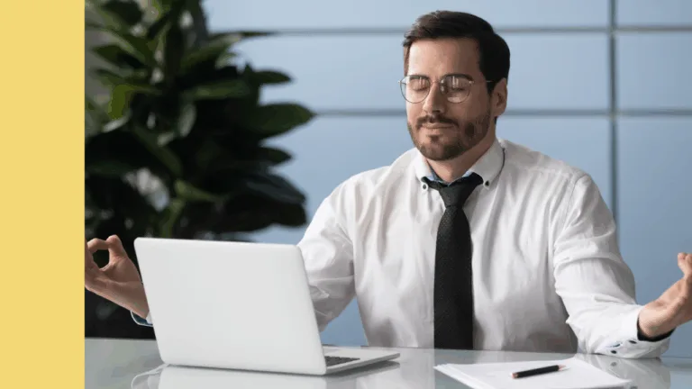 Professional working sitting at desk in front of laptop meditates calmly