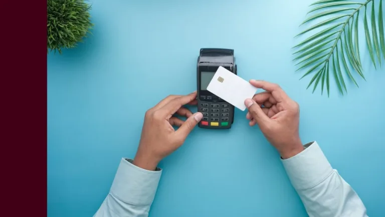 A man is using his credit card to tap on a wireless EFTPOS payments terminal