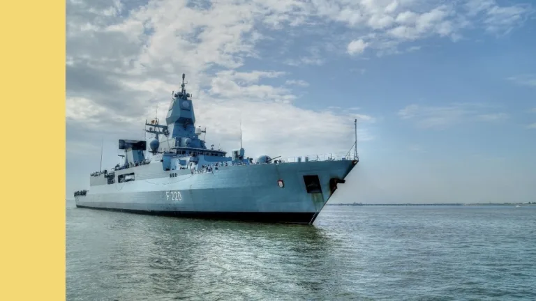 New Navy ship cruising across calm water