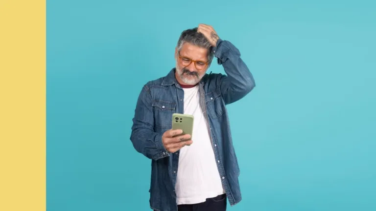 man looking at phone appears confused by what he is reading