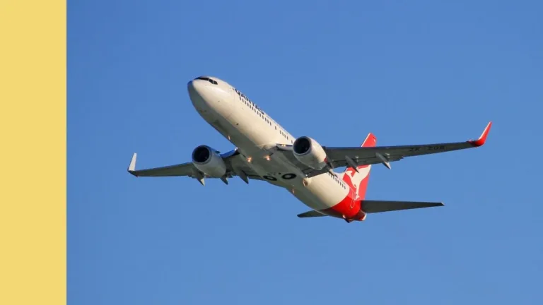 qantas plane taking off into blue sky