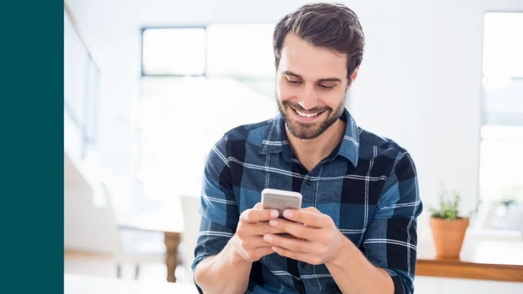 man is happy looking at phone